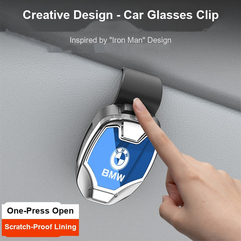 BMW sunglasses clip close-up showing one-press open mechanism, bright silver