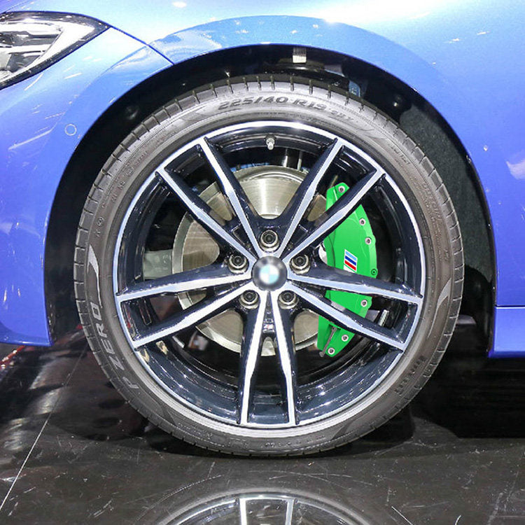 BMW wheel with green M-style brake caliper cover installed, close-up