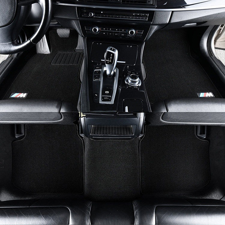 BMW black velvet floor mats installed in center console footwell