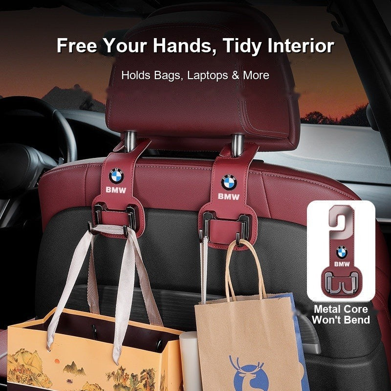 BMW seat hooks holding shopping bags and a laptop bag in the car