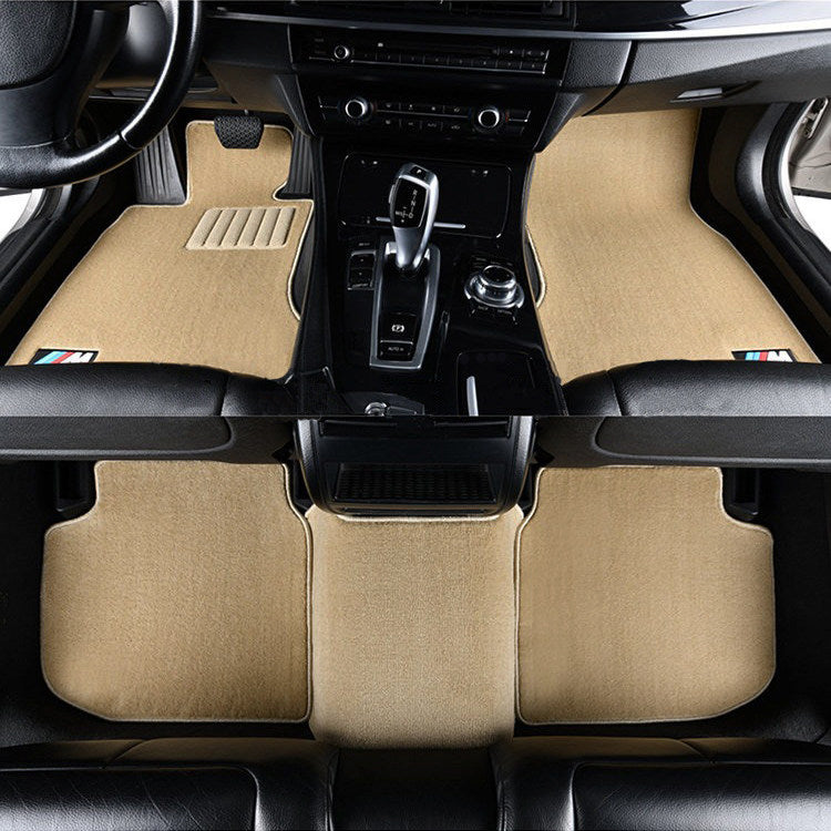 BMW beige velvet floor mats installed in center console footwell