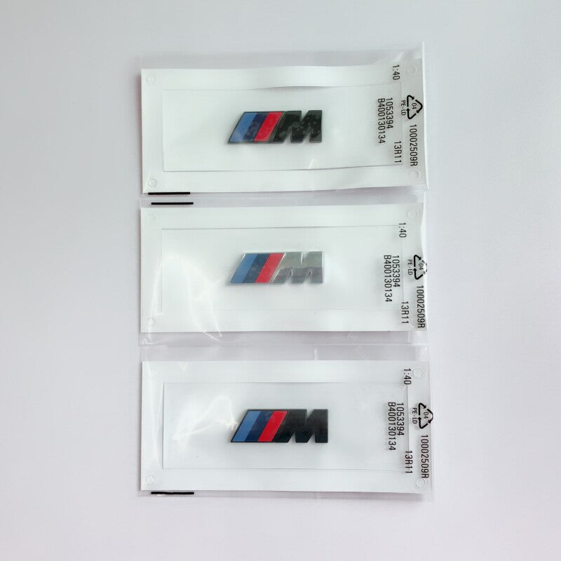 BMW large M side badge packaging in three finishes