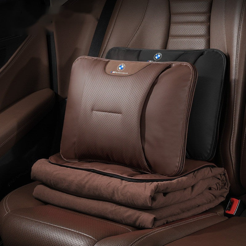 BMW car lumbar pillow and blanket set on rear seat, brown leather cushion