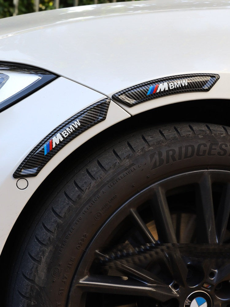 BMW M-style carbon fiber bumper guard installed on wheel fender