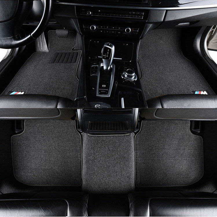 BMW light gray velvet floor mats installed in center console footwell