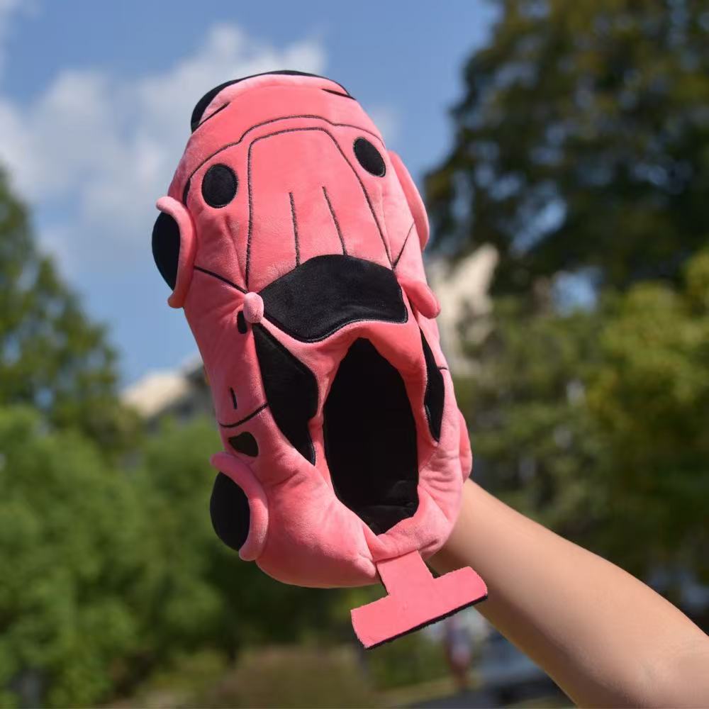 Pink sports car plush slipper held up outdoors