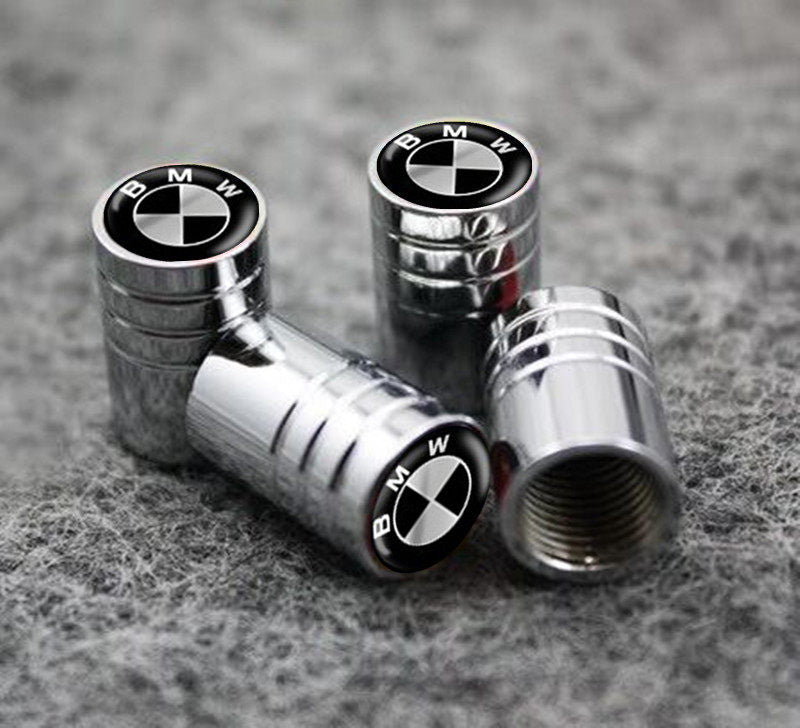 BMW roundel silver tire valve caps on textured background