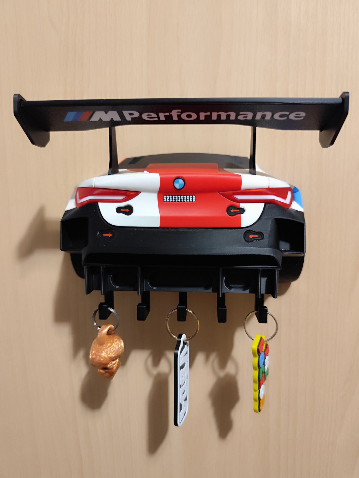 BMW M4 GT3 wall key holder mounted with keys hanging from hooks