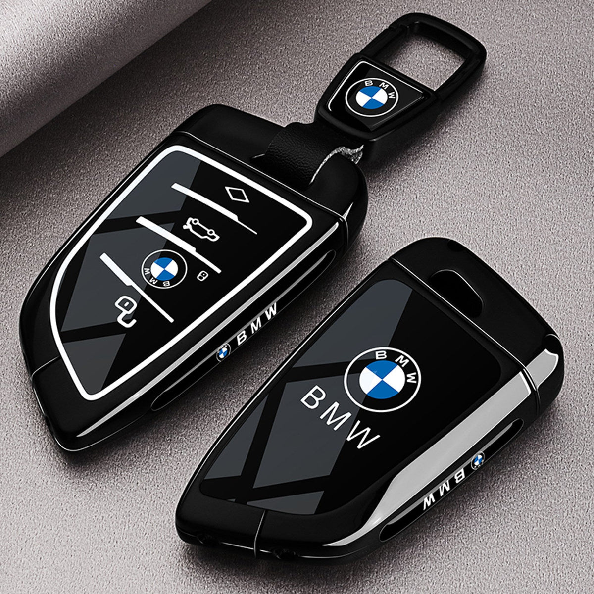 BMW smart key fob case - front and back view showing glossy black shell with BMW logo
