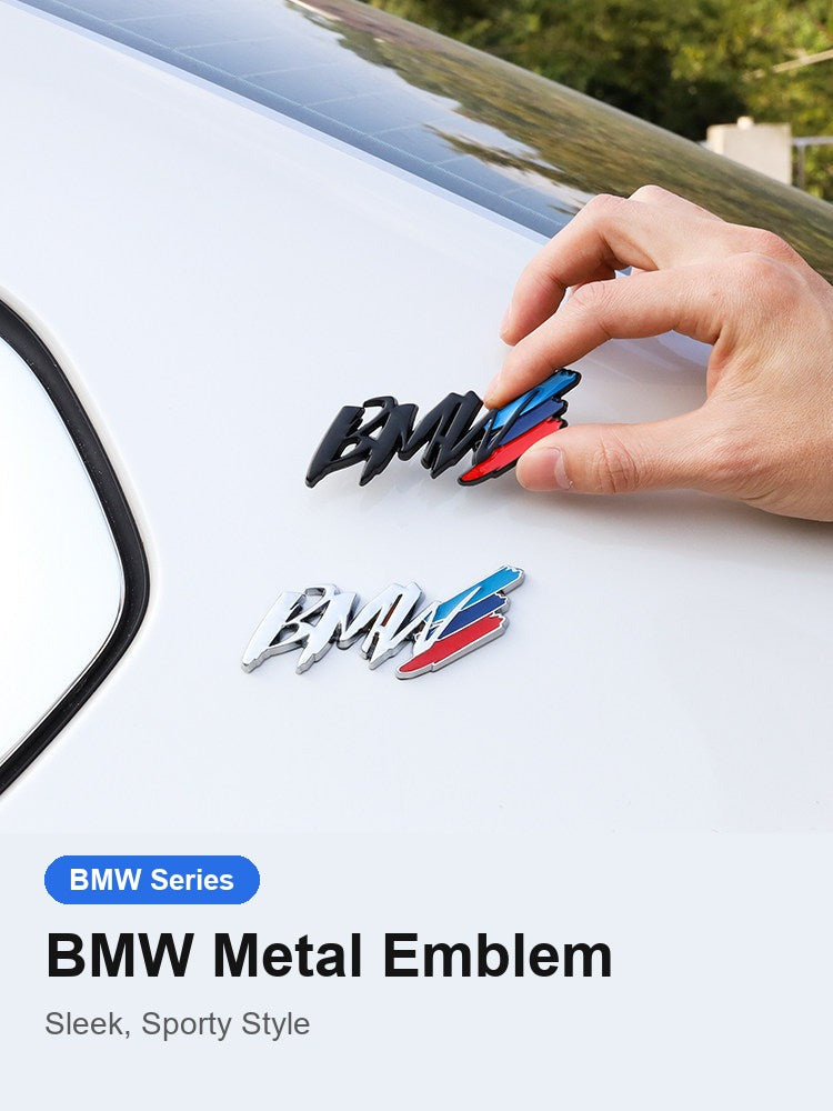 BMW tricolor metal badge being applied to a car fender by hand