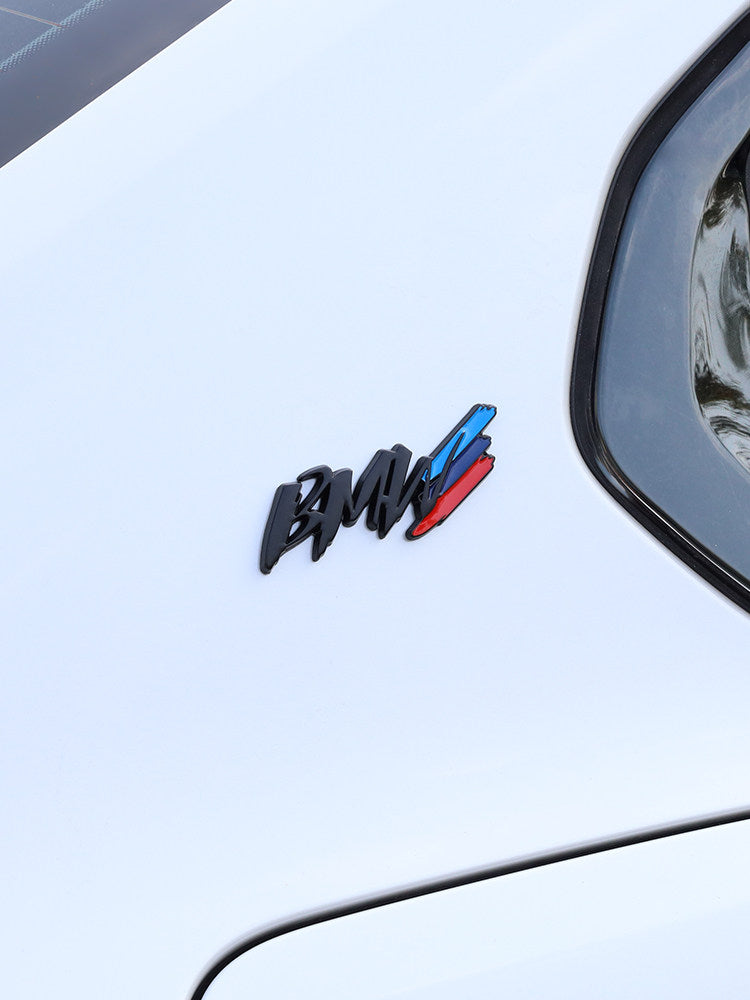 BMW metal badge installed on white car door panel