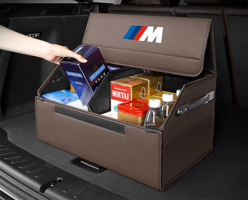BMW trunk storage box holding drinks, snacks, and boxed goods neatly in the trunk