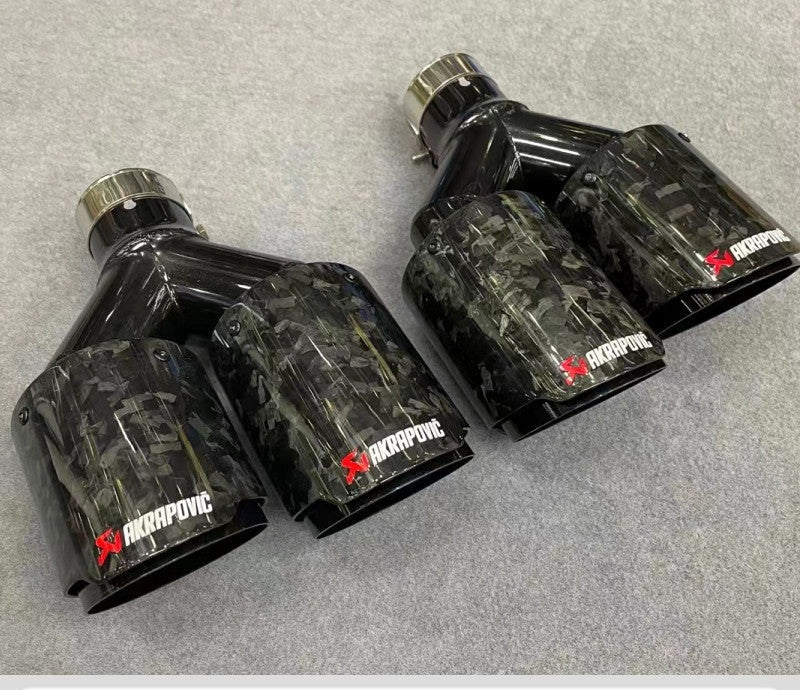 Carbon fiber quad exhaust tips for BMW and Audi, angled view showing forged steel construction