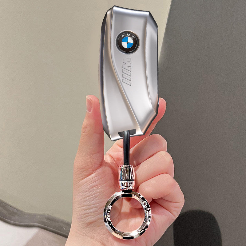 BMW key case silver with basic keyring held in hand