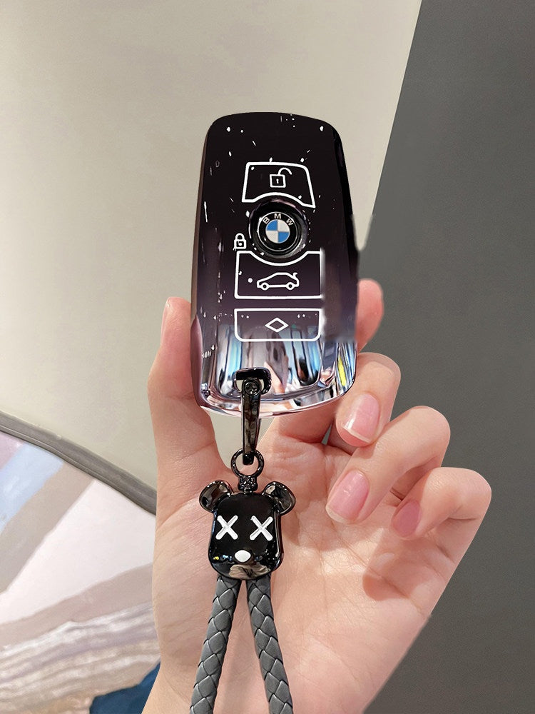 BMW smart key in starry sky black TPU sleeve with bear keychain charm, front view