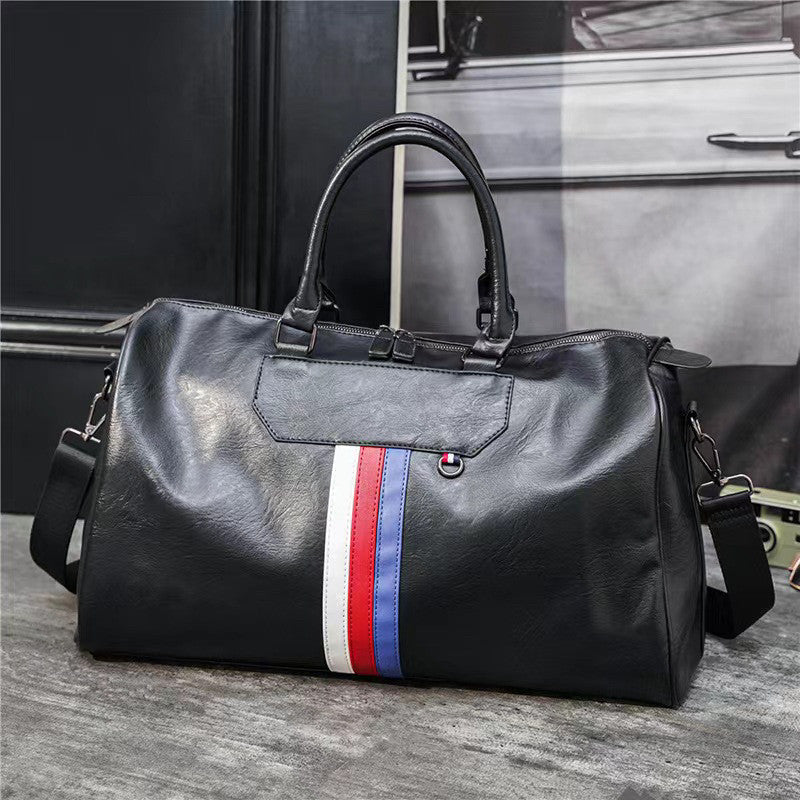 BMW duffel bag close-up of leather brand tag and tricolor stripe