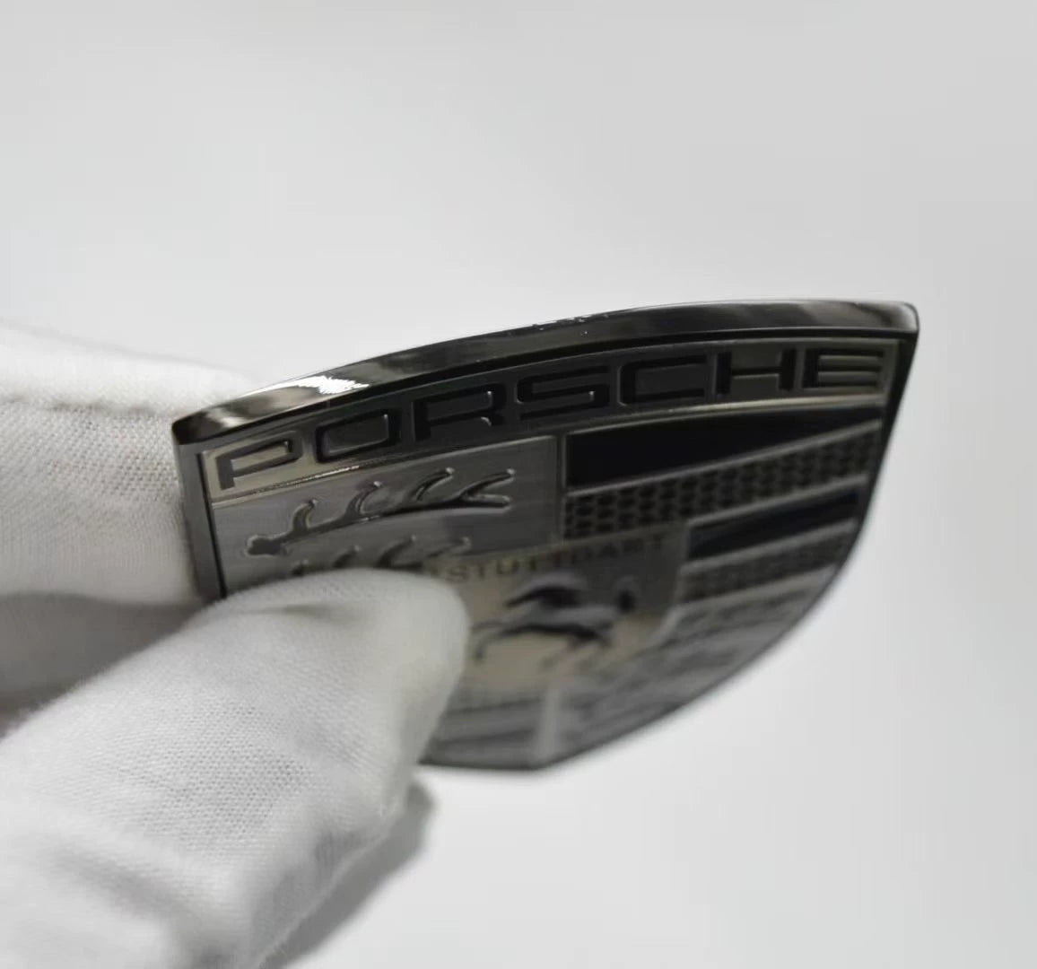 Porsche smoked gray crest hood badge – slim profile side view