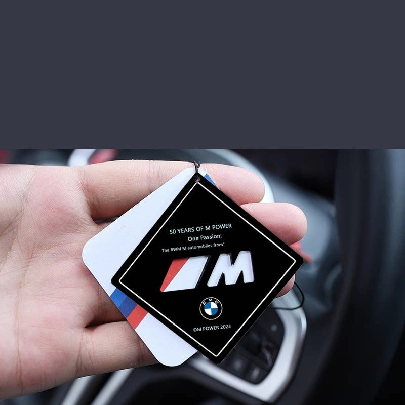 BMW M Power air freshener held in hand showing diamond design