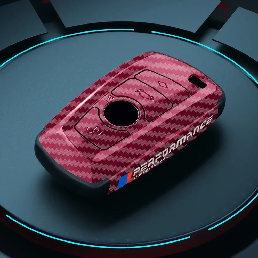 BMW carbon fiber key case, red accent, studio lighting