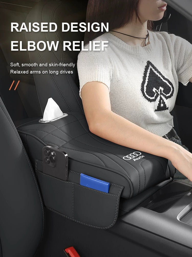 Raised Audi armrest cushion supporting the driver elbow