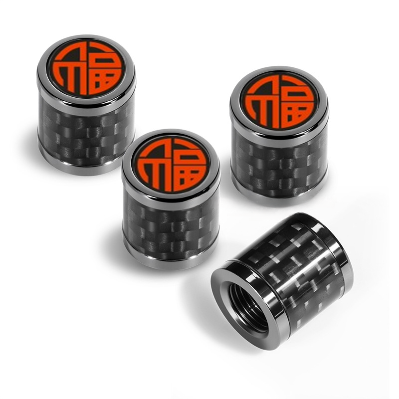 Carbon fiber valve caps with orange Fu lucky symbol emblem
