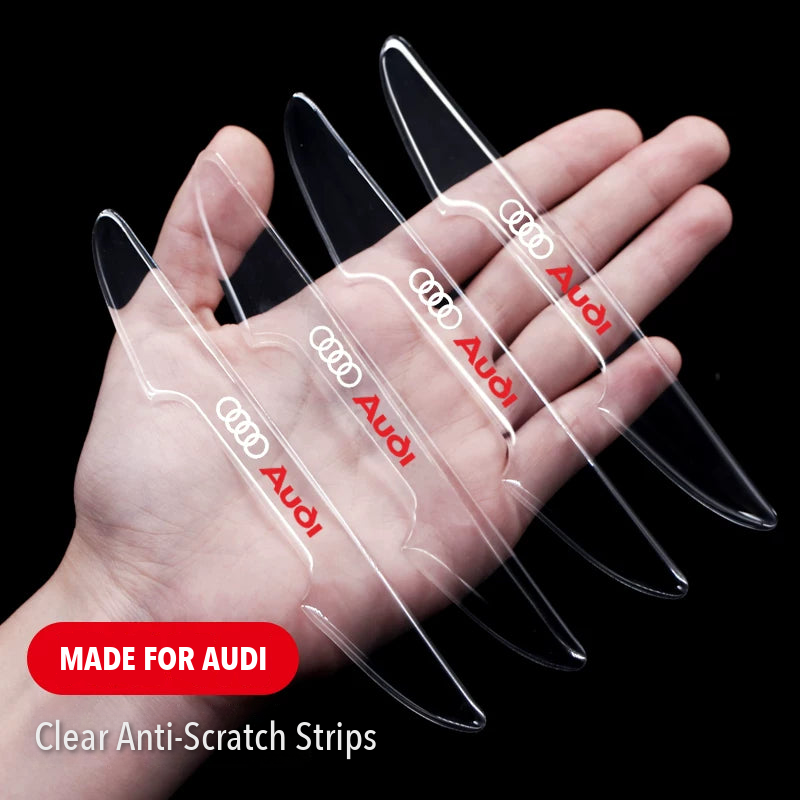 Four clear Audi door edge guard strips with red Audi logo held in hand