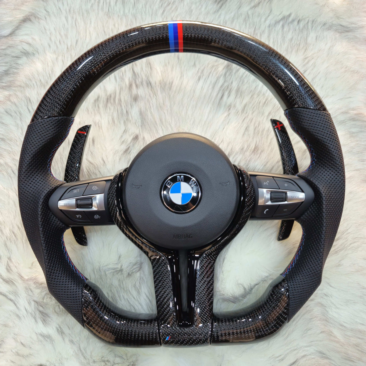 Carbon fiber steering wheel with black trim and carbon paddle shifters for BMW F Series - front view