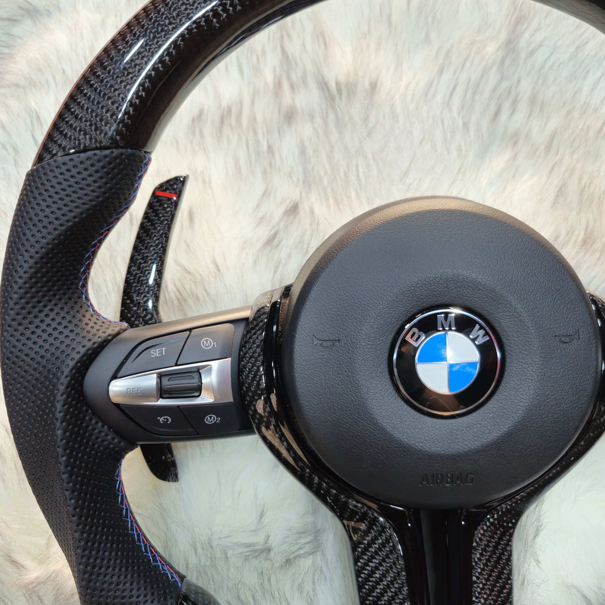Carbon fiber steering wheel with carbon paddle shifters for BMW F Series - left side close-up