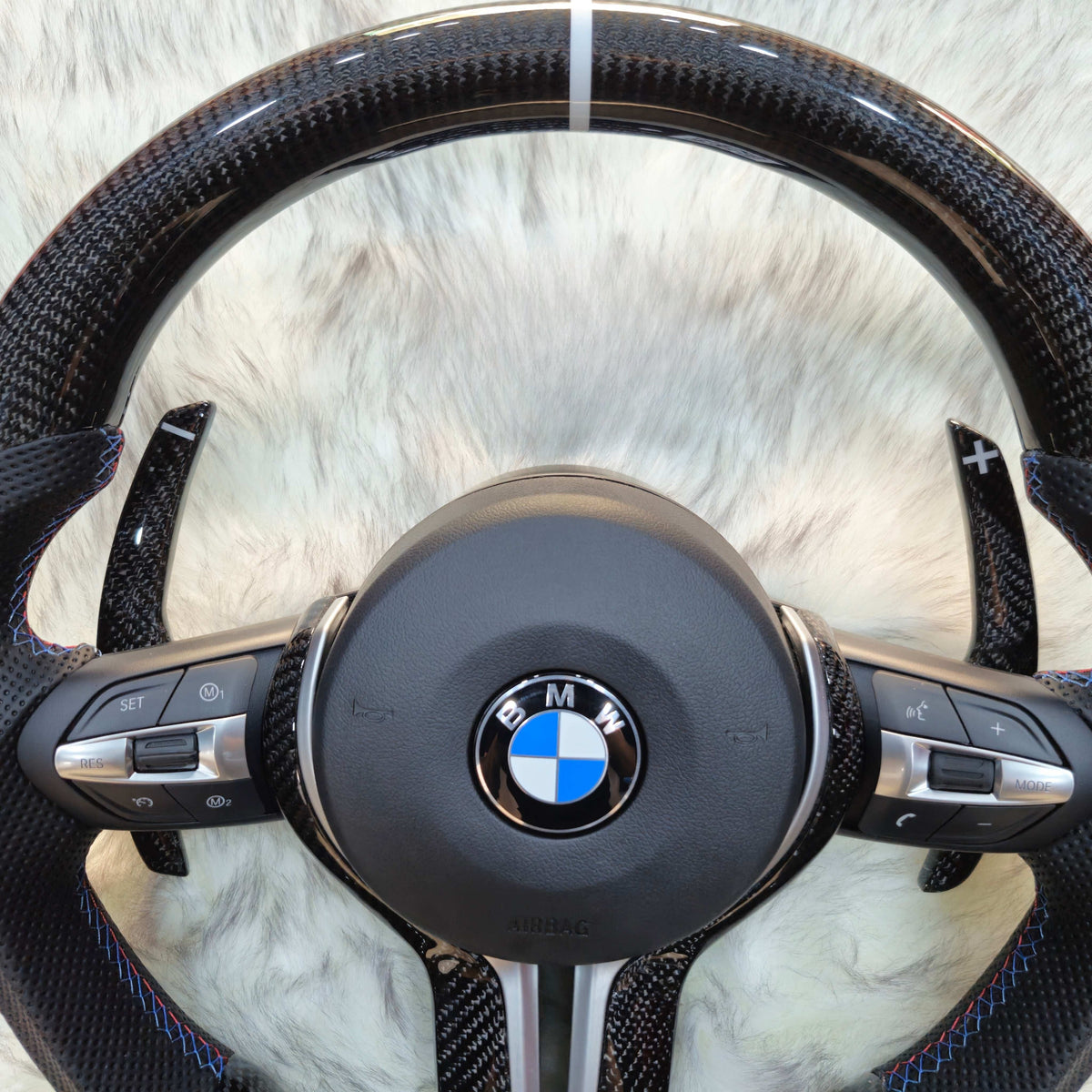 Carbon fiber steering wheel with silver trim for BMW F Series - carbon top section close-up