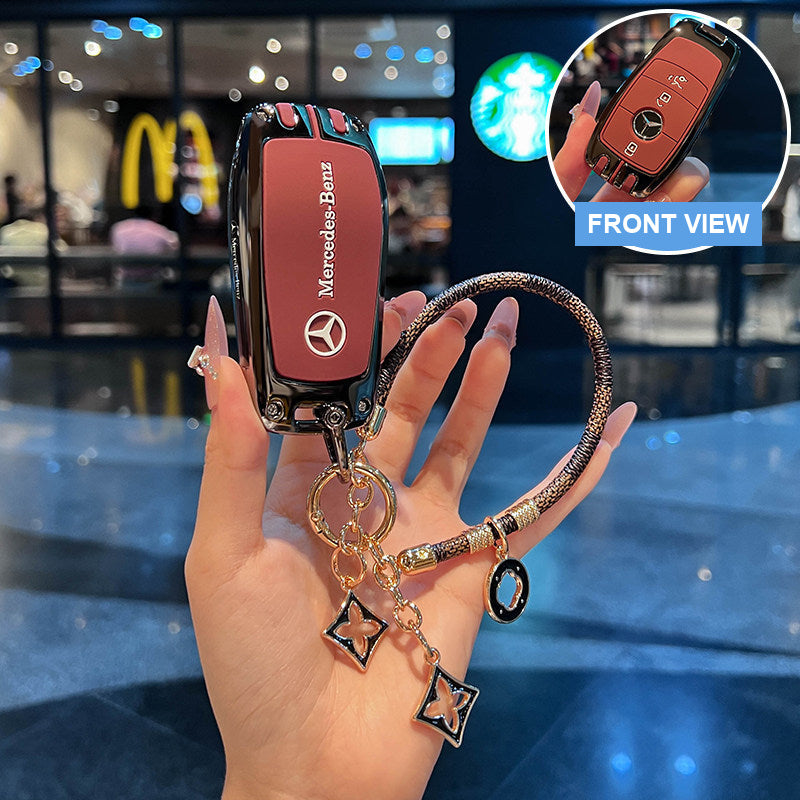 Red Mercedes-Benz key case with braided strap and clover charms