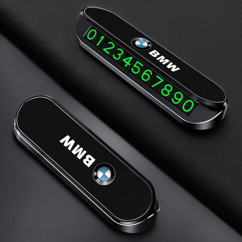 Red BMW LED temporary parking sign on car dashboard