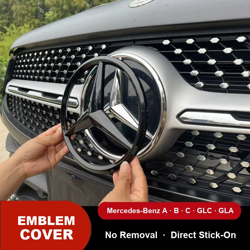 Mercedes-Benz front grille star emblem cover in gloss black being fitted over the original badge