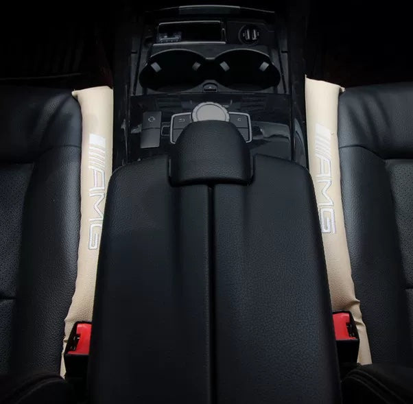 Beige AMG embroidered seat gap fillers either side of a Mercedes-Benz centre console