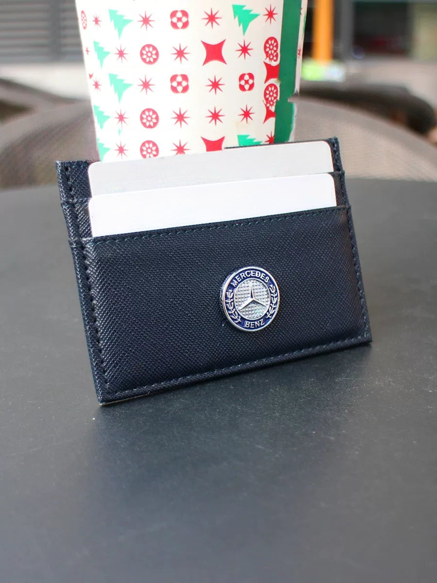 Mercedes-Benz slim card holder in navy with laurel emblem, cards in slots