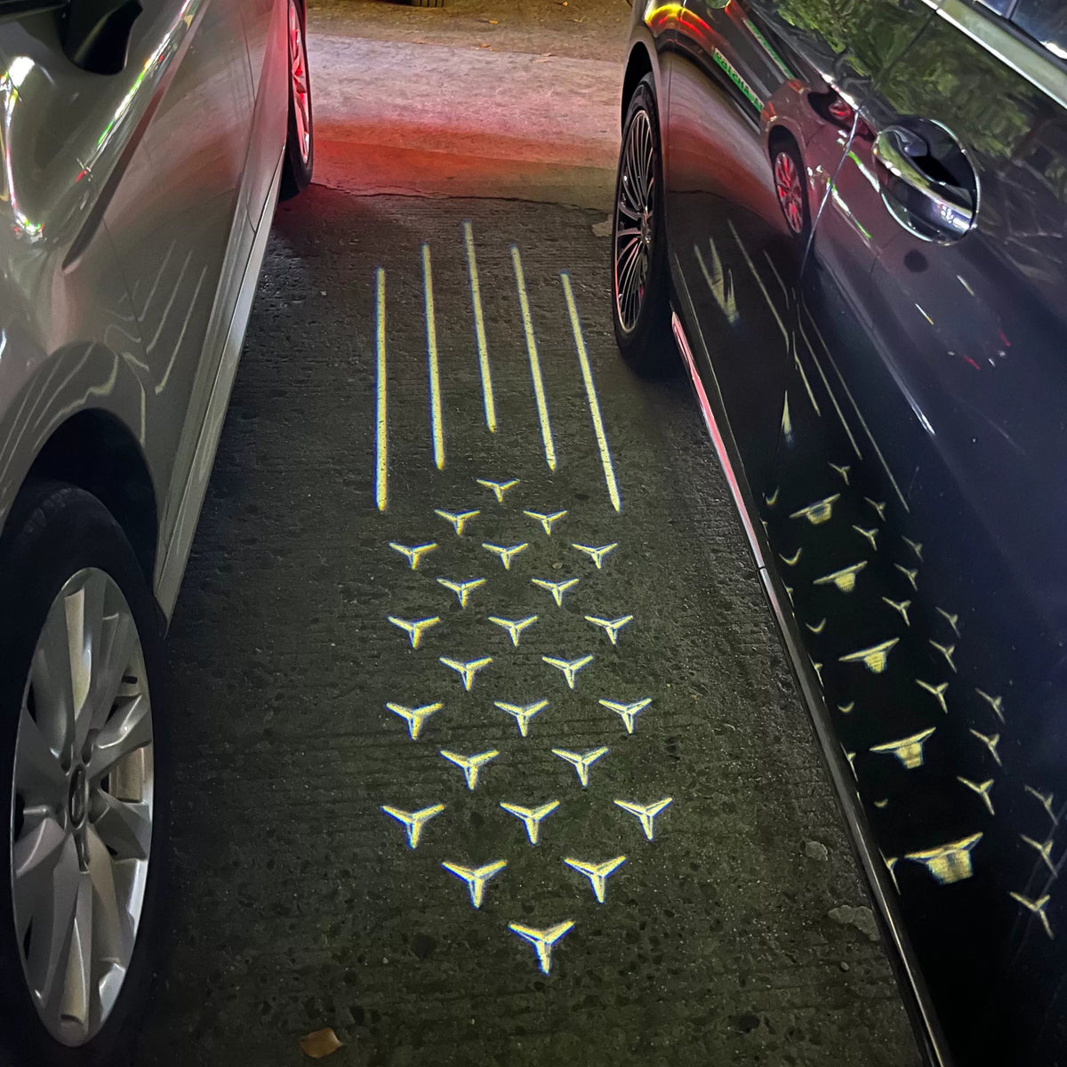 Starfall side mirror ground projection with five light trails and a cascade of Mercedes stars
