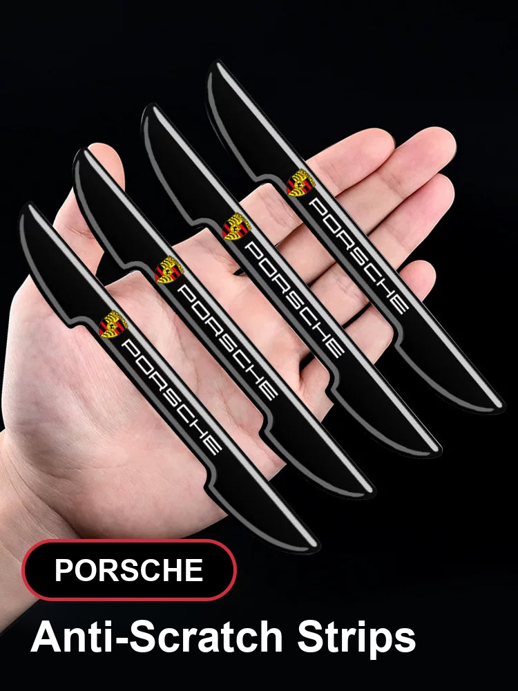Porsche crest door edge guards in Blade Black, set of four held in hand